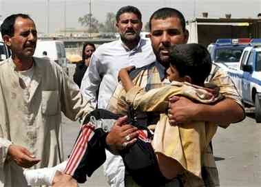 Child being carried into al-kindi hospital after bombing