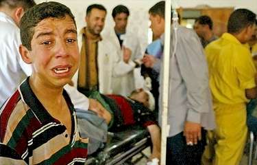 Child crying in Baqouba hospital for his injured father