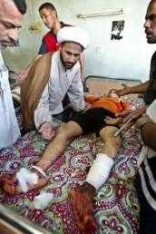 Sadr city Shiite clergyman visiiting young bombing victim in hospital July 23rd 2006