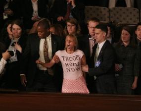 Protester being removed from congress during Maliki's speech