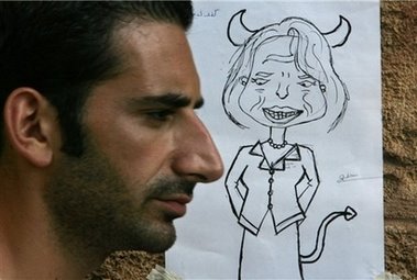 Photograph taken Beirut July 29th 2006 The photogaph shows a man standing next to a sketch of Condoleeza Rice Rice is depicted as a cartoon devil
