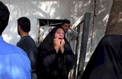 iraqi woman weeping leaving hospital morgue