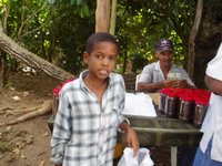 A young man helping his pappy with sales of coffee and coco