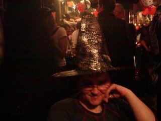 Me wearing a witches hat with silver cobwebs on it