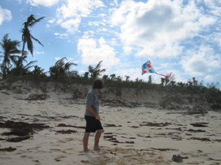 flying a kite on the ocean beach