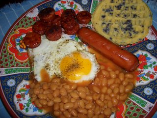 a nice meal to start the day...sunny-side up egg, sliced portuguese sausages, shoyu sausage, baked beans and blueberry waffles