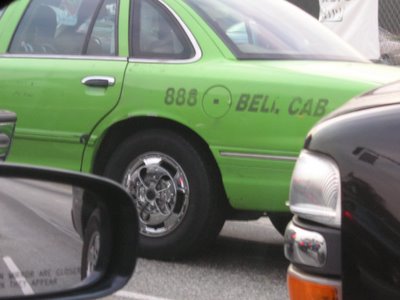 [Image: Green cab with spinner wheels]
