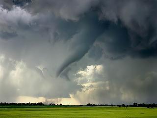 twister emerging from clouds