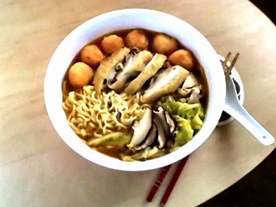 bowl of noodles with fish balls, steamed free-range chicken, shiitake mushrooms and chinese nappa