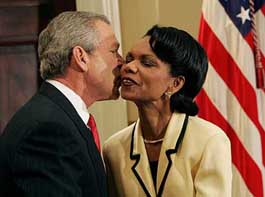 President Bush gives newly appointed Secretary of State the traditional air-kiss congratulations.