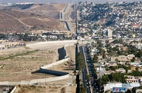 Three layers of fences separate the U.S. and Mexico (R) along the border in San Diego December 9, 2005. Mexican President Vicente Fox denounced as 'disgraceful and shameful' on Wednesday a proposal to build a high-tech wall on the border to stop illegal immigrants. (Fred Greaves/Reuters)