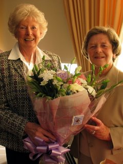 Constance Wright presented with a bouquet of flowers from New Captain Pat Walker