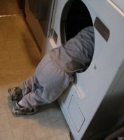 Kid playing in the dryer