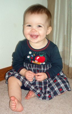 E at 15 1/2 months, wearing apple dress