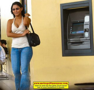 ATM machine latina girl standing beside with a Sony VAIO Laptop