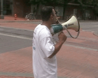 alex ansary bullhorning downtown portland on july 4, 2006