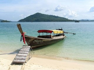 You hire a longtail from Laem Hin to reach Koh Rang