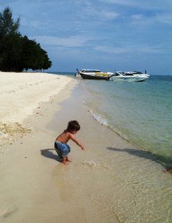 The kid having fun with the sand on Koh Rang