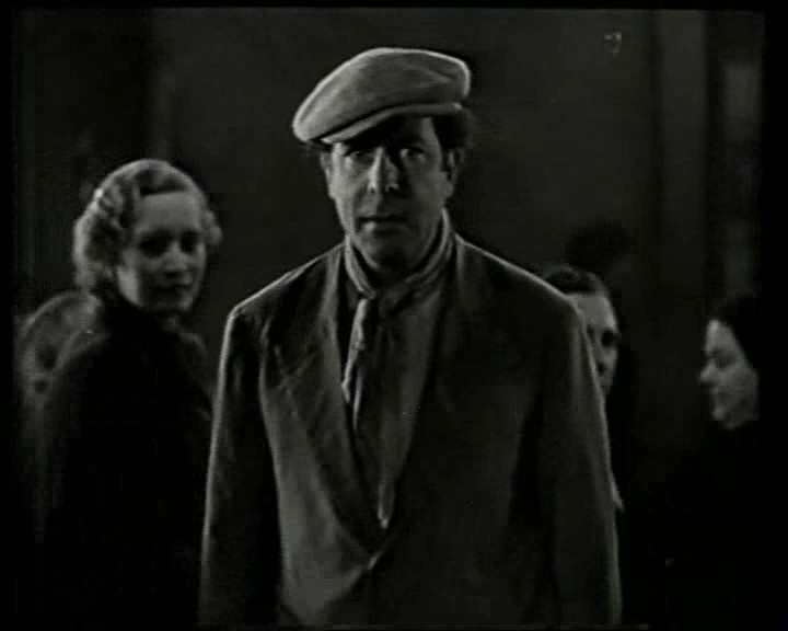 Movie still from Aurora de Esperanza (Sau, 1937) with man facing camera and woman looking back at him