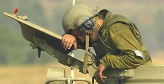 An Israeli gunner rests on top of a artillery piece near Kiryat Shmona, northern Israel, next to the Lebanese border. Photograph: Sebastian Scheiner/AP