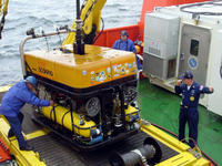 In this U.S. Navy file photo of the remotely operated vehicle 'Super Scorpio,' Petty Officer 1st Class Charles Holter (right) directs the Super Scorpio back aboard the submersible support and submarine rescue ship Delores Chouest on May 24, 2002, during Exercise Sorbet Royal 2002, a NATO-sponsored live submarine search and rescue exercise off the coast of Denmark. U.S. Navy photo   (Click photo for screen-resolution image);