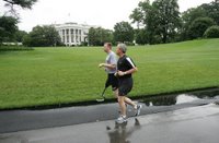 President George W. Bush runs with U.S. Army Staff Sergeant Christian Bagge, 23, of Eugene, Ore., on the South Lawn Tuesday, June 27, 2006. President Bush met Sgt. Bagge at Brooke Army Medical Center Jan. 1, 2006, where he promised to run with Sgt. Bagge. Since then, Sgt. Bagge has reenlisted to active duty. White House photo by Eric Draper.