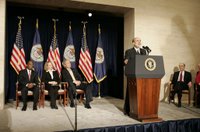 With his predecessor, Alan Greenspan, looking on, Chairman Ben Bernanke addresses President George W. Bush and others after being sworn in to the Federal Reserve post. Also on stage with the President are Mrs. Anna Bernanke and Roger W. Ferguson, Jr., Vice Chairman of the Federal Reserve. White House photo by Kimberlee Hewitt.