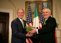 President George W. Bush is presented a bowl of shamrocks by Prime Minister Bertie Ahern of Ireland, during a ceremony Friday, St. Patrick's Day 2006, in the Roosevelt Room of the White House. White House photo by Kimberlee Hewitt.