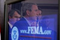 President George W. Bush's reflection is seen in a television monitor as he outlines further assistance to victims of Hurricane Katrina, Thursday, Sept. 8, 2005 in the Eisenhower Executive Office Building in Washington. White House photo by Paul Morse.