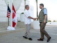 President George W. Bush shakes hands with Canadian Prime Minister Stephen Harper, Thursday, March 30, 2006 in Cancun, Mexico, in their first meeting since Harper was elected Prime Minister. President Bush is participating in a three-day summit with the leaders of Mexico and Canada. White House photo by Kimberlee Hewitt/