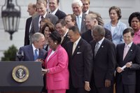 President George W. Bush talks with U.S. Representative Sheila Jackson Lee, D-Texas, during the signing of H.R. 9, the Fannie Lou Hamer, Rosa Parks, and Coretta Scott King Voting Rights Act Reauthorization and Amendments Act of 2006, on the South Lawn Thursday, July 27, 2006. White House photo by Paul Morse.