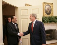 President George W. Bush welcomes Iraqi Prime Minister Nouri al-Maliki into the Oval Office of the White House Tuesday, July 25, 2006, where the two leaders talked about plans to expand the security presence in the neighborhoods of the Iraqi capital. White House photo by Eric Draper.