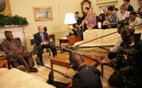 President George W. Bush speaks to the press as they gather Wednesday, March 29, 2006, in the Oval Office for a photo availability with President Olesegun Obasanjo of Nigeria. President Bush thanked President Obasanjo for his leadership and said, 