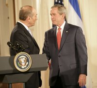 President George W. Bush and Prime Minister Ehud Olmert of Israel exchange handshakes Tuesday, May 23, 2006, at the end of a joint press availability in the East Room of the White House. White House photo by Eric Draper.