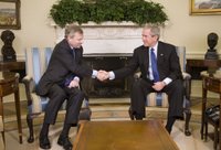 President George W. Bush welcomes NATO Secretary General Jaap de Hoop Scheffer to the Oval Office at the Whiite House, Monday, March 20, 2006 in Washington. White House photo by Kimberlee Hewitt.