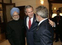 President George W. Bush embraces India’s Prime Minister Dr. Manmohan Singh, left, and Brazilian President Luiz Inacio Lula da Silva, right, at the Konstantinovsky Palace Complex Monday, July 17, 2006. President Bush met with the two leaders separately in bilateral meetings during the G8 Summit in Strelna, Russia. White House photo by Eric Draper.