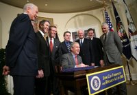 President George W. Bush smiles as he signs into law H.R. 2520, the Stem Cell Therapeutic and Research Act of 2005, during ceremonies Tuesday, Dec. 20, 2005, in the Roosevelt Room of the White House. White House photo by Paul Morse.