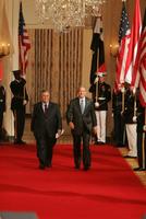 President George W. Bush and President Jalal Talabani of Iraq walk to the East Room of the White House Tuesday, Sept. 13, 2005, for a joint press availability. The President called Iraq 'America's ally in the war against terrorism,' and added, 'freedom will win in Iraq.' White House photo by Shealah Craighead