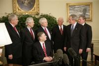 President George W. Bush meets with former justices of the Texas Supreme Court Monday, Oct. 17, 2005, in the Oval Office of the White House. From left are: Former Associate Justice Eugene Cook; former Associate Justice Raul Gonzalez; Texas Attorney General and former Associate Justice Greg Abbott, seated; former Texas Chief Justice John Hill; former Associate Justice James Baker; the President, and former Associate Justice Craig Enoch. White House photo by Eric Draper