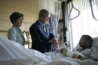 President George W. Bush and Mrs. Laura Bush talk with Sgt. Patrick Hagood of Anderson, S.C., Wednesday, Oct. 5, 2005, during their visit to Walter Reed Army Medical Center in Washington D.C. White House photo by Paul Morse