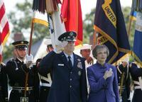 General Richard B. Myers salutes as he stands with his wife, Mary Jo Myers, Friday, Sept. 30, 2005, during ceremonies at The Armed Forces Farewell Tribute in Honor of General Richard B. Myers and the Armed Forces Hail in Honor of General Peter Pace at Fort Myer's Summerall Field in Ft. Myer, Va. White House photo by David Bohrer