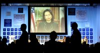 Secretary Rice speaks on screen by video link, during a plenary session entitled 'The Guiding Principles and Values for U.S. Politicies' at the World Economic Forum in Davos, Switzerland, Thursday Jan. 26, 2006. [© AP/WWP]