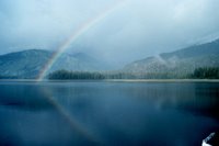 An Alaskan rainbow - note reflection on the water. Image ID: corp2029, NOAA Corps Collection, Photo Date: September 1992,Photographer: Commander John Bortniak, NOAA Corps.