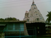 The huge Kankeshwar Shiva Temple, with a gold tip over the top.