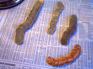 Picture of pennies and other coins on a copy of a financial newspaper