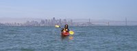 Sylvia kayaking, with SF in the background