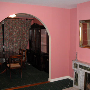 Pink sitting room with a real fireplace.
