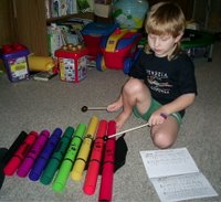 Max playing colored musical tubes