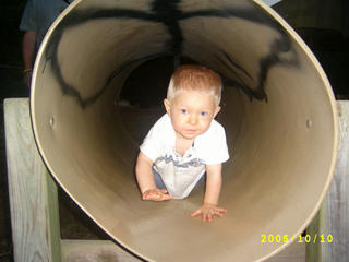 Crawling through tube at playground