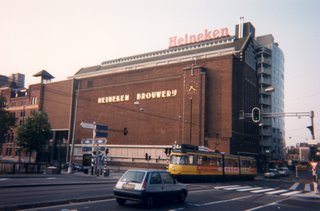 Greg hanging from sign in front of Heineken Brewery